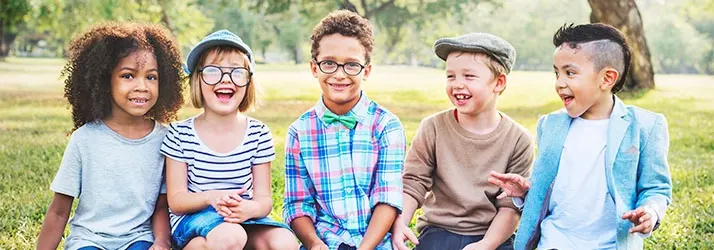 Chiropractic Ocoee FL Laughing Kids Outside Five kids sitting in outside laughing.