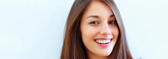 Chiropractic Ocoee FL Pain Free Smiling Lady A woman with brown hair smiling.