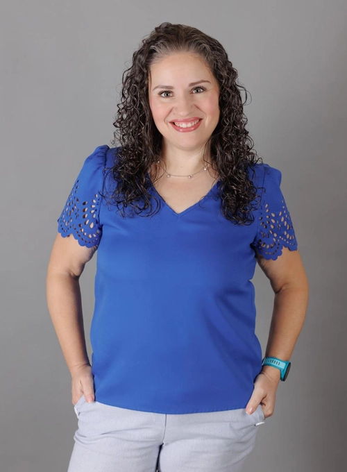 Dr. Nicole Palmer smiling in a blue shirt.